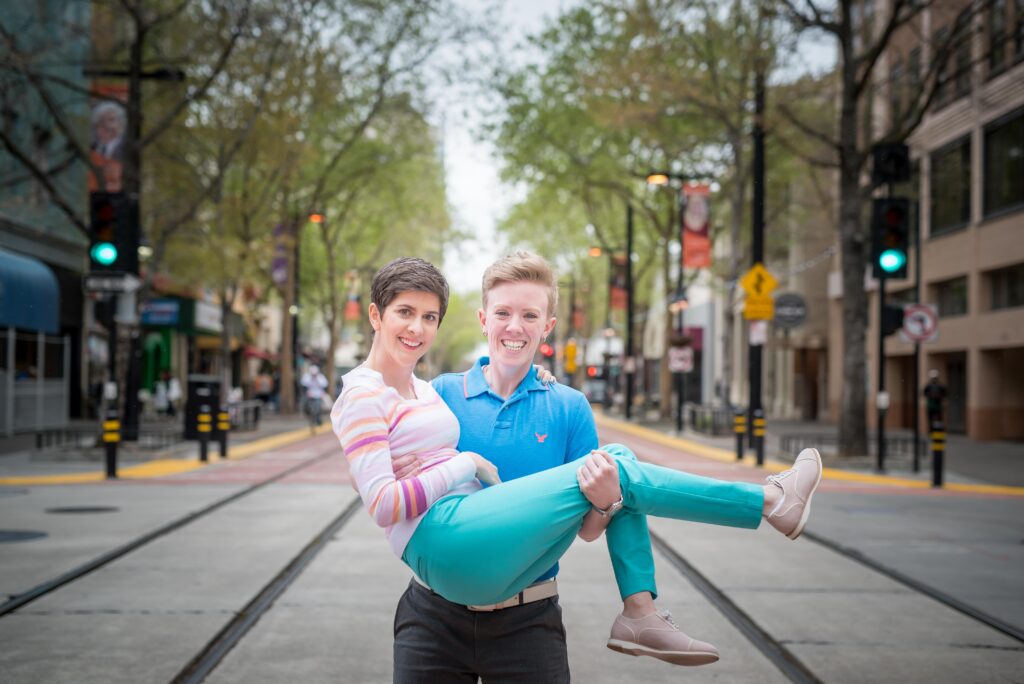 Female couple standing in middle of downtown during a family session