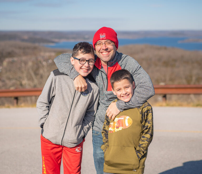 Portrait of a dad and his two sons in Branson, Missouri.