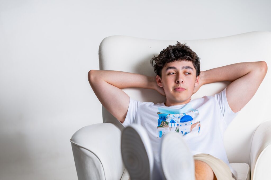 Older boy relaxing on a chair with his feet up