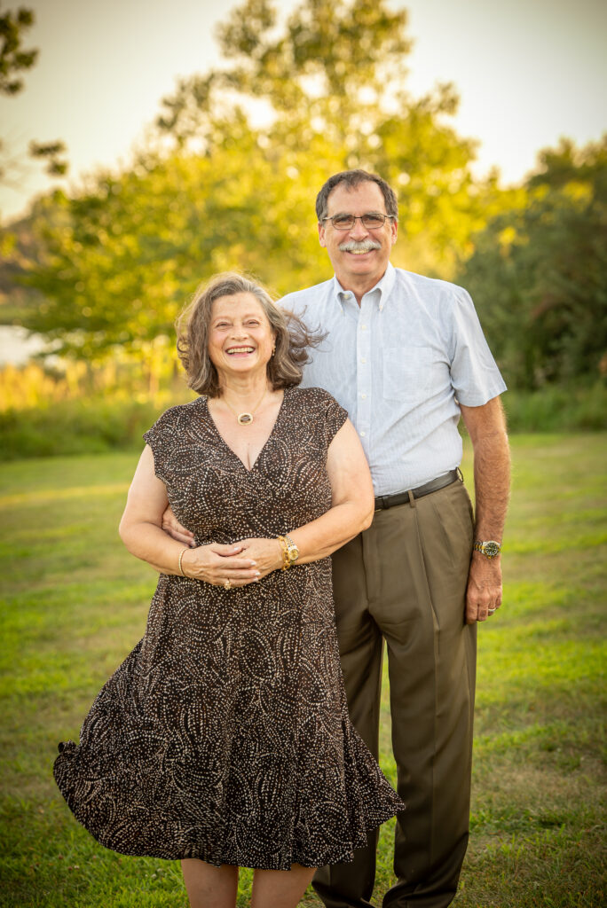 An older couple smiling and standing next to each other during an omaha family session