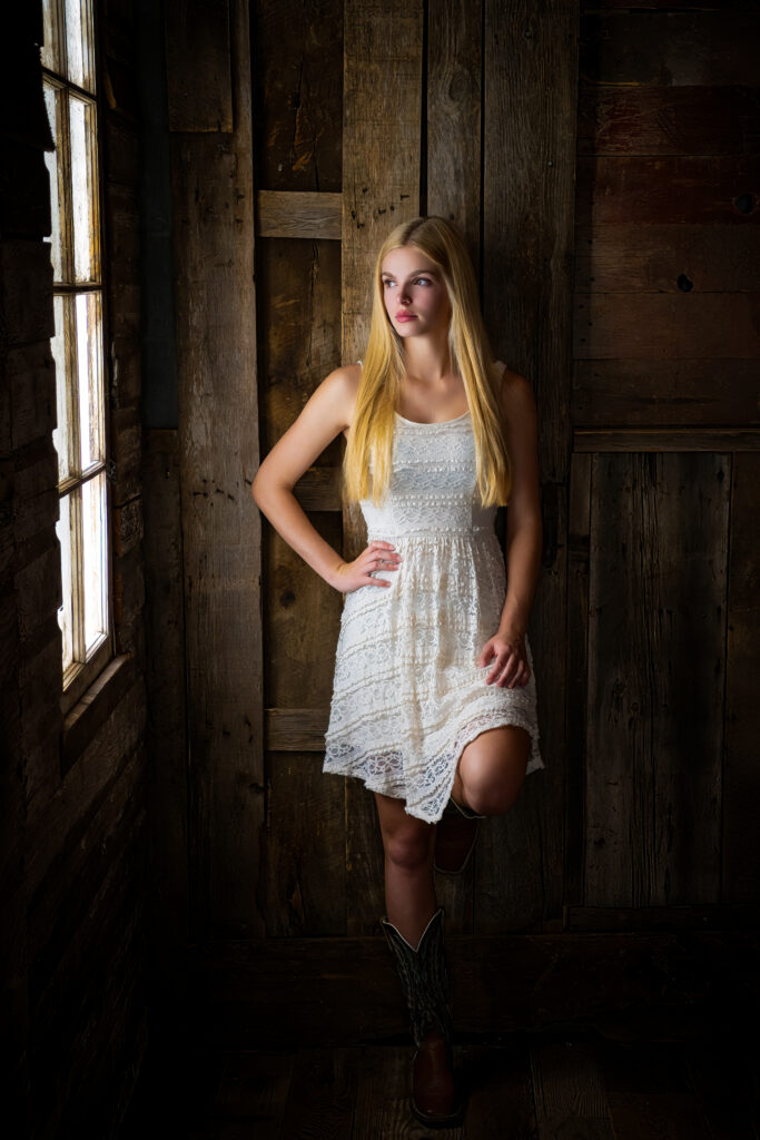 High school senior is white dress and boots 