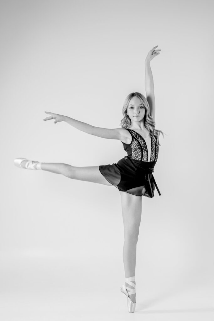 A young dancer in black and white in a black skirt