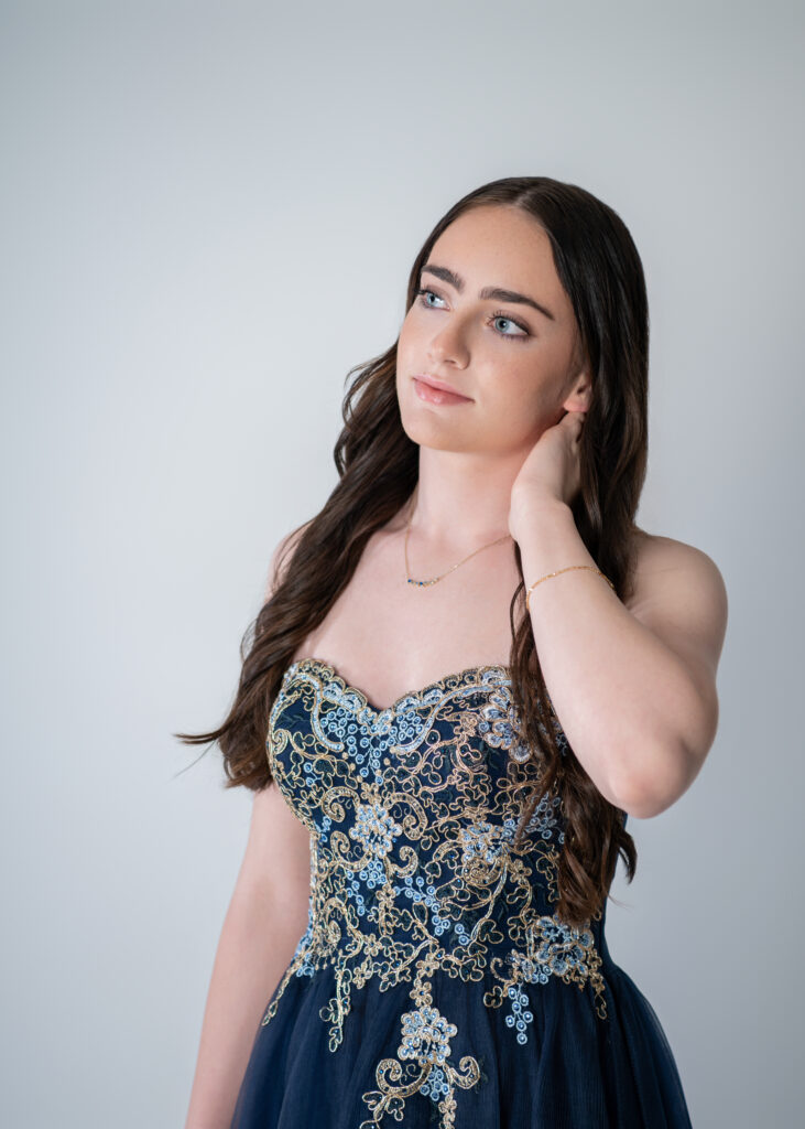 Female high school senior in her ballgown in candid look