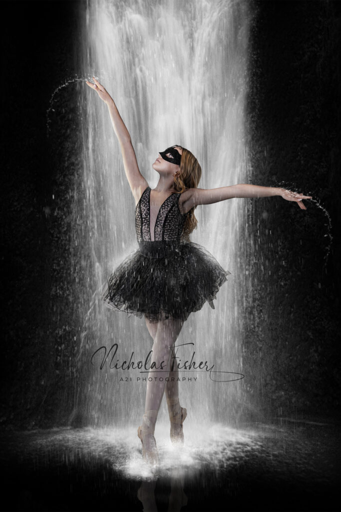 Young dancer in a mask beneath a waterfall in a composite photo.